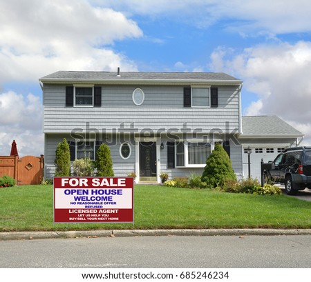 Real Estate For Sale Sign Suburban two story gray ranch home USA blue sky clouds