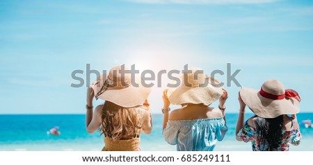 The women dressed in Bohemian clothing style is relaxing on the beach in vacation time. Royalty-Free Stock Photo #685249111