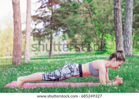 young woman performing plank position 