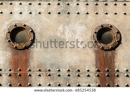 Ship Vintage Cabin Portholes
Ship cabin portholes marine engineering vintage rivets steel plates closeup texture background.