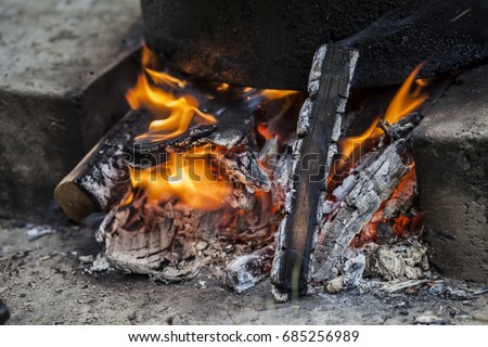 burning coals and flames background in the grill.