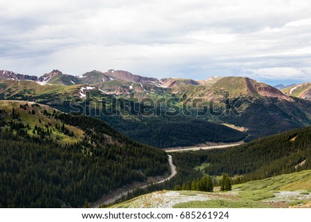rocky mountains with winding road
