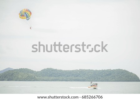 Picture of a people is on the Parasailing.
