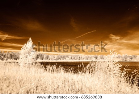 infrared camera image. colored. reflections of clouds in water in countryside