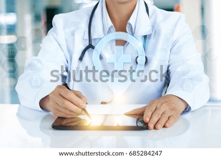 Medical worker shows the location of the hospital on the tablet.