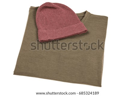 Top view flat lay beanie & folded t-shirt isolated on white background 