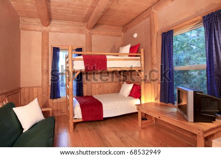 Log cabin bedroom with bunk bed.