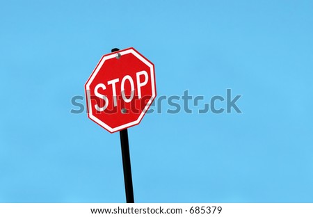 Stop sign against blue sky.