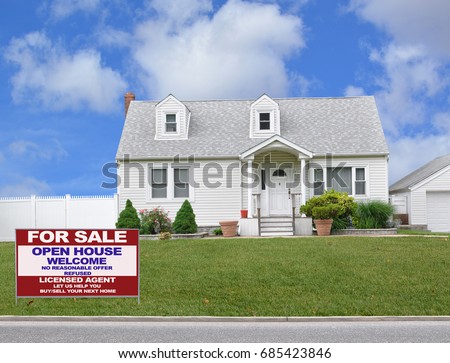 Real Estate for sale sign front yard lawn White Suburban bungalow home blue sky clouds USA