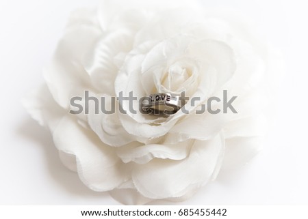 wedding ring on white rose for valentine's day