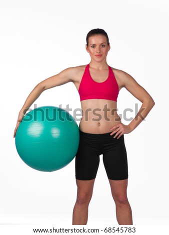 strong young woman in fitness clothes with pilates ball