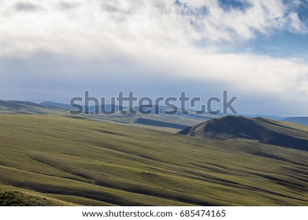 Rolling hills, blue sky, clouds, green grass, large field