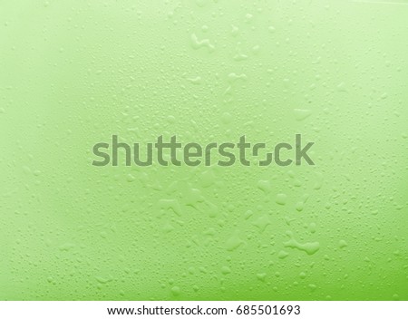 Drops, water splashes on green background. Cute simple background, backdrop. Top view. Close-up. Stock photo