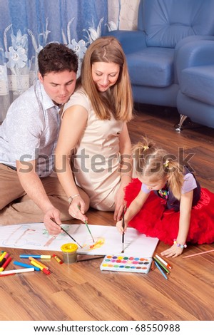Family amicably draw on a floor