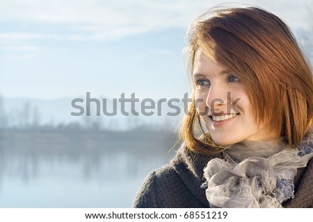 Portrait of the girl against a landscape