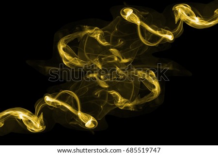 Beauty gold smoke on dark background,movement gold of fire flame smoke, Abstract and texture of amazing magic gold smoke on black background