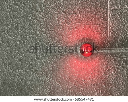 red light attach on rough surface cement with copy space on the left hand