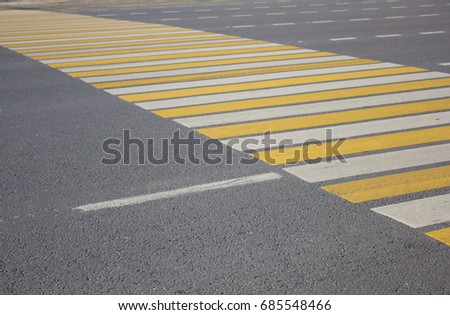 Large pedestrian crossing striped white and yellow