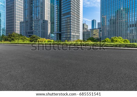 cityscape and skyline of shanghai from empty asphalt road