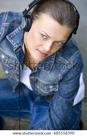 young adult girl enjoying good weather, listening to music