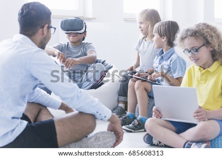 Afro-american boy uses VR glasses during information technology lesson Royalty-Free Stock Photo #685608313