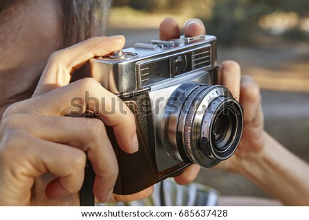 Woman taking pictures with vintage camera. Travel background. Vacation 