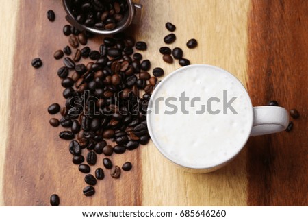 Hot latte , hot coffee and milk foam on wood floor