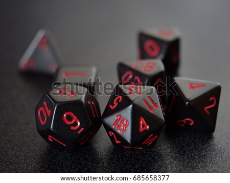 A collection of black gaming dice used for table top gaming