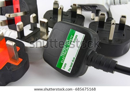 side view of plugs Background of  three pin plugs with top of plug  with test sticker Royalty-Free Stock Photo #685675168