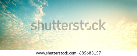 Early morning sky scene with sunrise, clouds, light rays and other atmospheric effect, horizontal image for wallpaper or banner for your design
