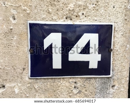 Vintage grunge square metal rusty plate of number of street address with number closeup