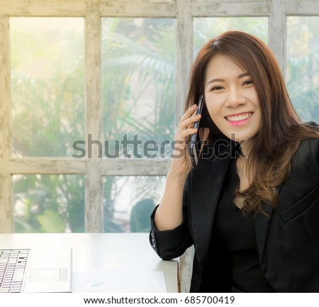 Happy asian businesswoman talking on cell phone in the office, Business woman talking smart phone, Age 20-30 years.