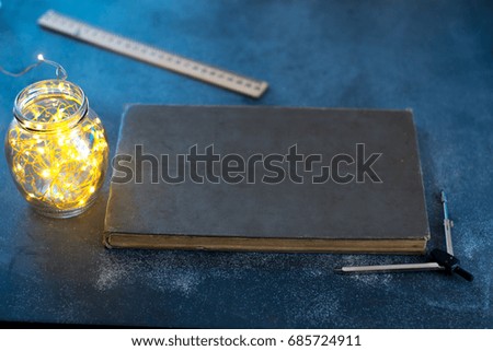 Dark background of an old book on a matte background with lights