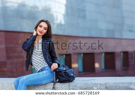 Young woman posing in black jacket. Fashion makeup