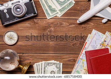 Photo of money, airplane, passports, globe on wooden background, empty place for inscription