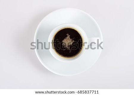 A cup of hot coffee on white, top view