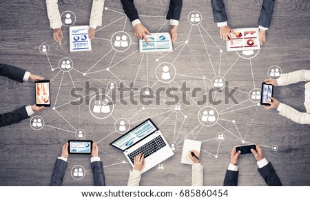 Group of people with devices in hands working together as symbol of networking and communication Royalty-Free Stock Photo #685860454