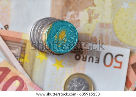 euro coin with national flag of kazakhstan on the euro money banknotes background. finance concept
