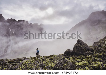 Tourist taking photo misty mountains