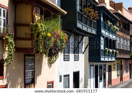 Famous ancient colorful balconies decorated with flowers in the city of Santa Cruz city on the island of La Palma island, Spain.