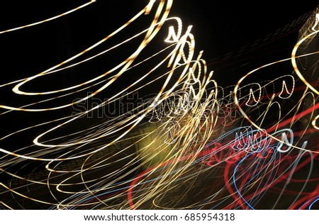 Colorful light waves. Motion blur. Abstract lighting transport with low speed shutter and dark background.