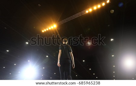 Rehearsal of finale session from Professional Woman Models on Ramp Stage with Full Scale Lighting on ceiling, shoot from behind no face, low exposure