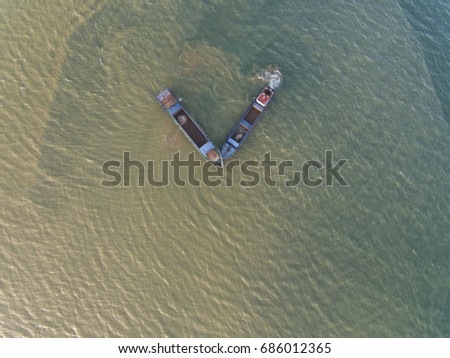 aerial view of a dredger ship between the Salt water and fresh water near estuary (brickish water)