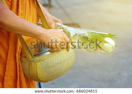 In Morning , Monk walk to be given food and lotus from Buddhist for continuing Buddhism.  Good look in Thai.