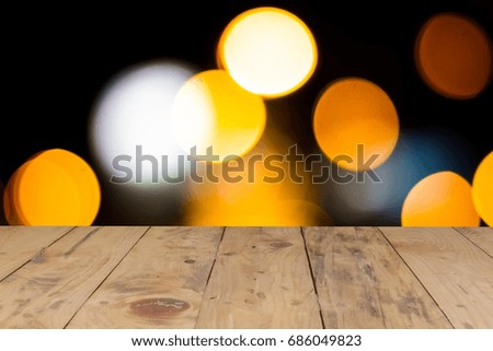 rustic wood table in front of lens blur glitter bright lights