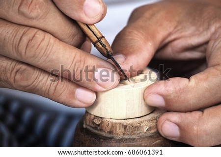 The carver making wood carving expertly