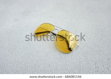 Yellow sunglasses on the floor with selective focus