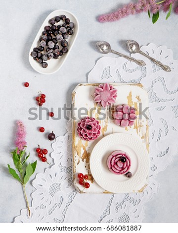 Currant organic frozen yogurt ice cream served on cutting board on lace napkin. Light grey stone background. Top view. Healthy food concept.
