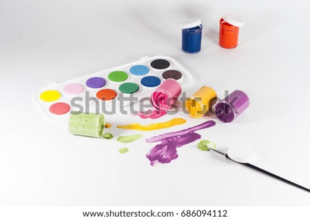 Back to school concept. Creative school concept, paintbrush and colorful paint. Isolated on white background top view. Kids set of watercolor paint and brush. Different color paint