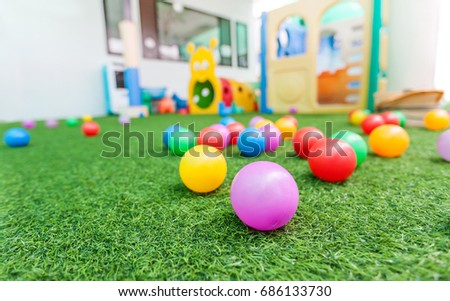 colorful plastic ball for kids on green turf at school playground Royalty-Free Stock Photo #686133730